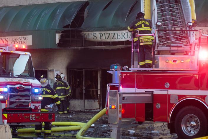 Firefighters from various towns battle a fire at the Green Hill Plaza strip mall in Parsippany, N.J. on Tuesday Jan. 4, 2022. 