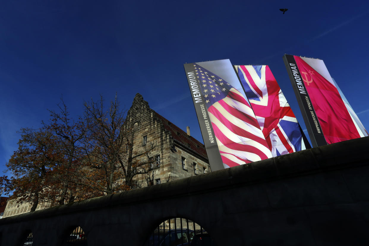 Flags of Great Britain, the United States, France an Russia stand in front of the palace of justice in Nuremberg, Germany, Wednesday, Nov. 18, 2020. Germany marks the 75th anniversary of the landmark Nuremberg trials of several Nazi leaders and in what is now seen as the birthplace of a new era of international law on Friday, Nov. 20, 2020. (AP Photo/Matthias Schrader)