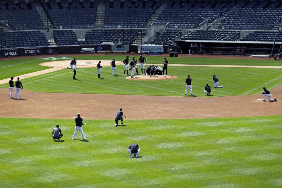 The New York Yankees team reacts after pitcher Masahiro Tanaka was hit in the head by a baseball during a team workout at Yankee Stadium in New York, Saturday, July 4, 2020. (AP Photo/Adam Hunger)