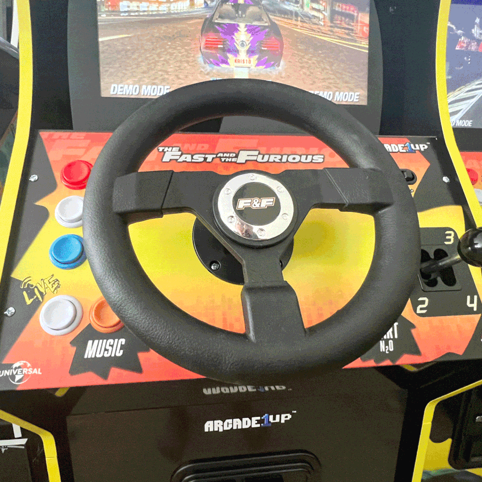 features of the arcade1up machine including wheel, shifter, speakers, and pedal