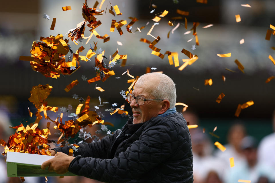 A protestor empties a box of confetti and puzzle pieces onto Court 18 at Wimbledon on Wednesday. (Reuters/Hannah Mckay)
