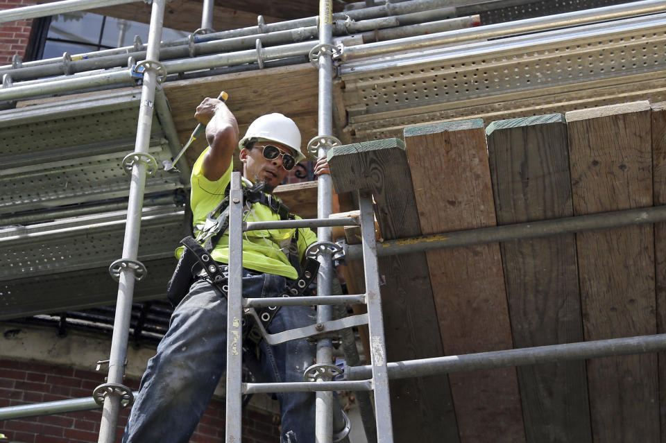 In this June 20, 2018 photo, a worker wields a hammer at a construction site in Boston. On Friday morning, the U.S. government will release its employment report for the month of August. (AP Photo/Elise Amendola)