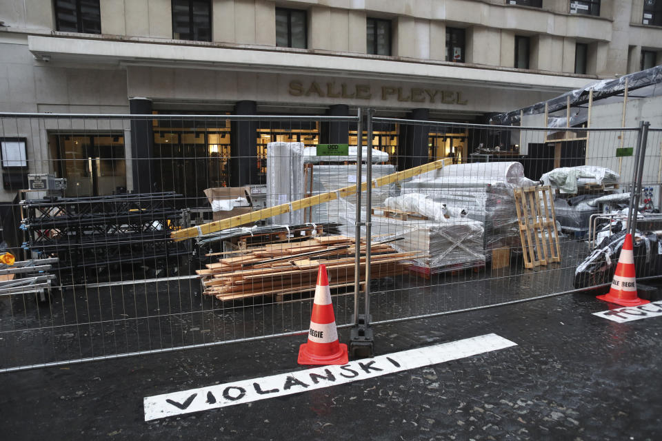 A graffiti in front of the venue of the Cesar Awards ceremony reads "Violanski", playing with the French word for rape and the name of Roman Polanski, Thursday, Feb. 27, 2020 in Paris. French women's rights activists are plastering banners to protest multiple nominations for Roman Polanski at the Cesar Awards ceremony, France's equivalent of the Oscars. This year's Cesars have been shaken by boycott calls since the nominations for Polanski's "An Officer and a Spy," because a French woman recently accused Polanski of raping her in the 1970s, which he denies. (AP Photo/Thibault Camus)