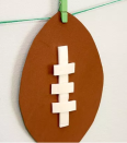 <p>These cute little footballs are easy to make and so versatile. You'll need string, brown foam paper sheets, mini clothes pins and white foam tape. You can hang them by a string like this blogger did, or stick 'em somewhere else — the choice is yours. </p><p><em><a href="http://www.ohsolovelyblog.com/diy-super-bowl-party-decor/" rel="nofollow noopener" target="_blank" data-ylk="slk:Get the tutorial at Oh So Lovely »;elm:context_link;itc:0;sec:content-canvas" class="link ">Get the tutorial at Oh So Lovely »</a></em> </p>