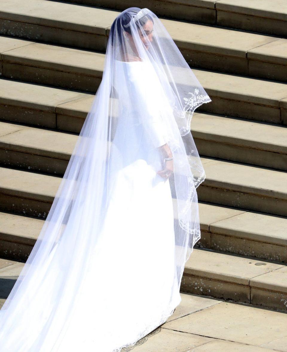 <p>The white bateua gown was designed by British designer Clare Waight Keller, the artistic director of French fashion house Givenchy. Markle chose Clare because of her “timeless and elegant aesthetic, impeccable tailoring, and relaxed demeanour,” Kensington Palace said. (Photo: PA) </p>