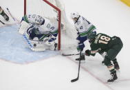 Minnesota Wild's Jordan Greenway (18) is stopped by Vancouver Canucks' goalie Jacob Markstrom (25) as Quinn Hughes (43) defends during second-period NHL hockey game action in Edmonton, Alberta, Thursday, Aug. 6, 2020. (Jason Franson/The Canadian Press via AP)