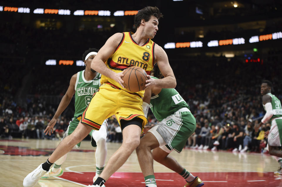 Atlanta Hawks forward Danilo Gallinari (8) spins past Boston Celtics guard Romeo Langford (9) during the second half of an NBA basketball game Friday, Jan. 28, 2022, in Atlanta. (AP Photo/Hakim Wright Sr.)