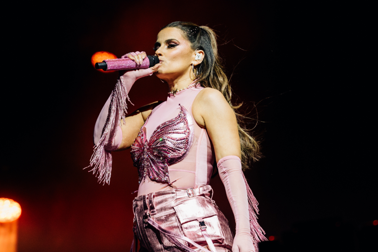 Nelly Furtado wearing a pink butterfly ensemble at Coachella 2024. 