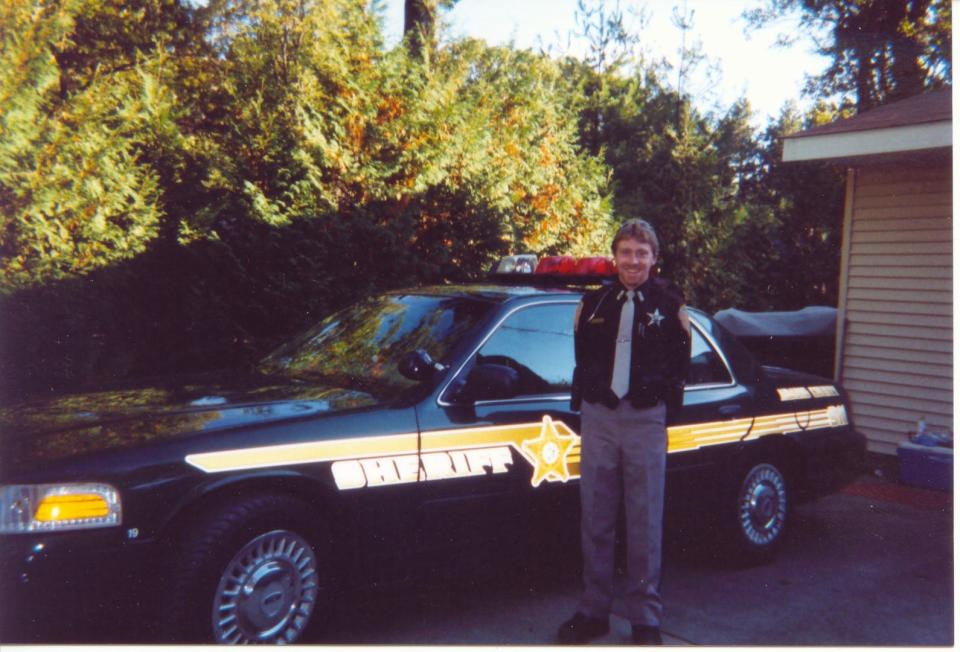Adams County Deputy Michael Shannon with his squad car.