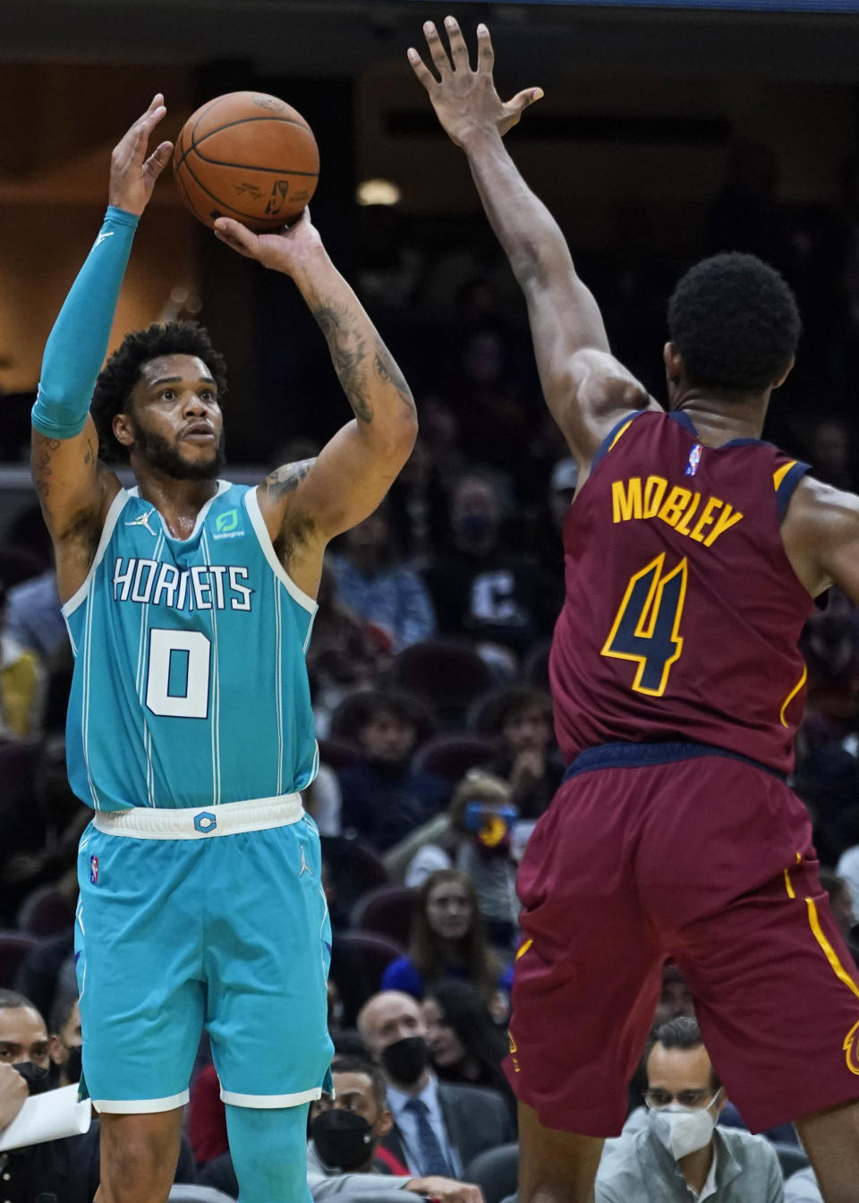 Charlotte Hornets' Miles Bridges (0) shoots over Cleveland Cavaliers' Evan Mobley (4) during the second half of an NBA basketball game Friday, Oct. 22, 2021, in Cleveland. Charlotte won 123-112. (AP Photo/Tony Dejak)