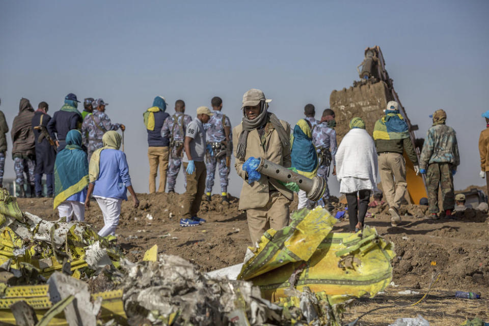 Workers gather at the scene of the Ethiopian Airlines flight crash near Addis Ababa (Picture: AP)