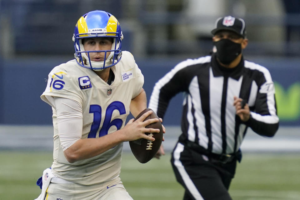 FILE - Los Angeles Rams quarterback Jared Goff (16) looks to pass against the Seattle Seahawks during the second half of an NFL football game in Seattle, in this Sunday, Dec. 27, 2020, file photo. Jared Goff is trying to return for the Los Angeles Rams' playoff game at Seattle just 13 days after thumb surgery. If he can't go, backup John Wolford will make his second NFL start. The Rams (10-6) are confident they can win with either man behind center.(AP Photo/Elaine Thompson, File)