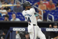 Miami Marlins' Bryan De La Cruz (14) hits a home run during the ninth inning of a baseball game against the Los Angeles Angels, Tuesday, April 2, 2024, in Miami. (AP Photo/Marta Lavandier)