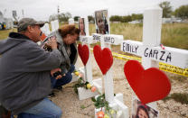 <p>Lorenzo Flores (L) and Terrie Smith react at a line of crosses in remembrance of those killed in the shooting at the First Baptist Church of Sutherland Springs, Texas, Nov. 9, 2017. (Photo: Rick Wilking/Reuters) </p>