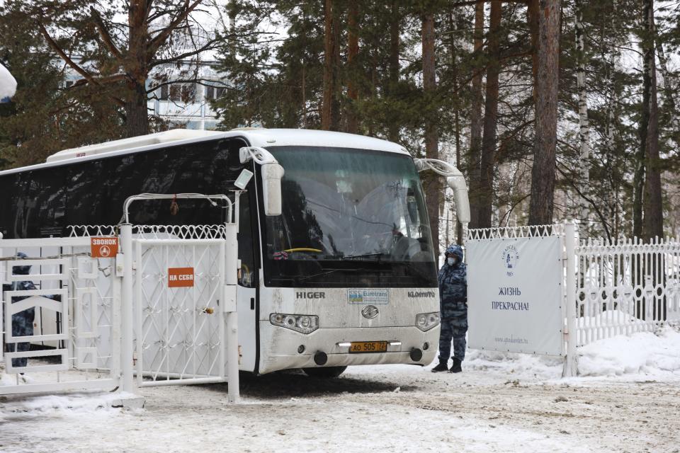 A bus parked at an entrance of the sanatorium in Bogandinsky in the Tyumen region, about 2150 kilometers (1344 miles) east of Moscow, western Siberia, Russia, Wednesday, Feb. 5, 2020, where the new virus outbreak evacuees will be quarantined for 14 days. Russia has evacuated 144 people, Russians and nationals of Belarus, Ukraine and Armenia - from the epicenter of the coronavirus outbreak in Wuhan, China, on Wednesday. All evacuees will be quarantined for two weeks in a sanatorium in the Tyumen region in western Siberia, government officials said. (AP Photo/Maxim Slutsky)