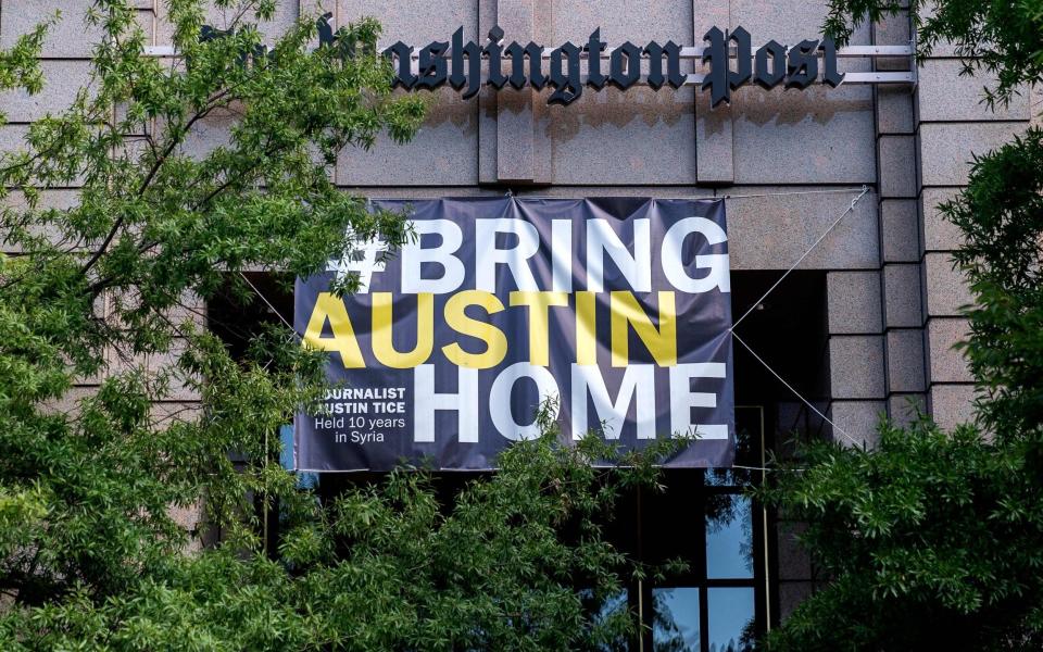 A banner reading Bring Austin Home is displayed outside The Washington Post building - AFP