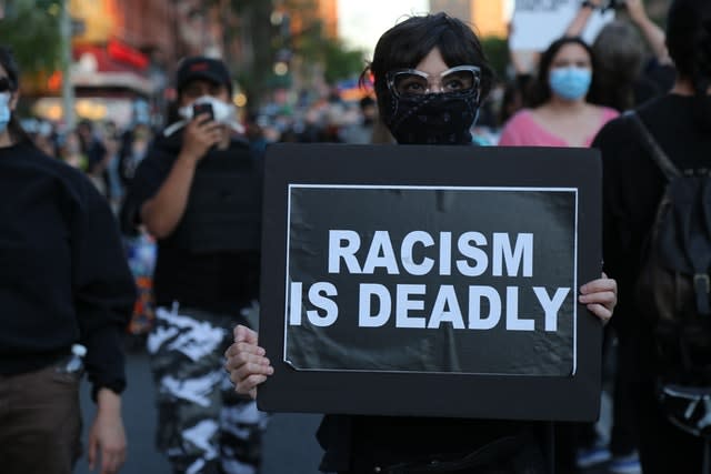 Protesters march down a street during a solidarity rally for George Floyd in the Brooklyn borough of New York