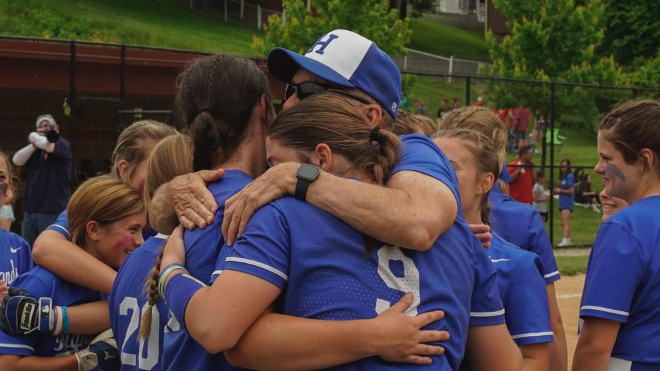 Highlands softball coach Milt Horner embraces Carley Cramer (left) and Kennedy Baioni (9) after the Bluebirds defeated Dixie Heights 4-2 in the Ninth Region championship game on May 28, 2023.