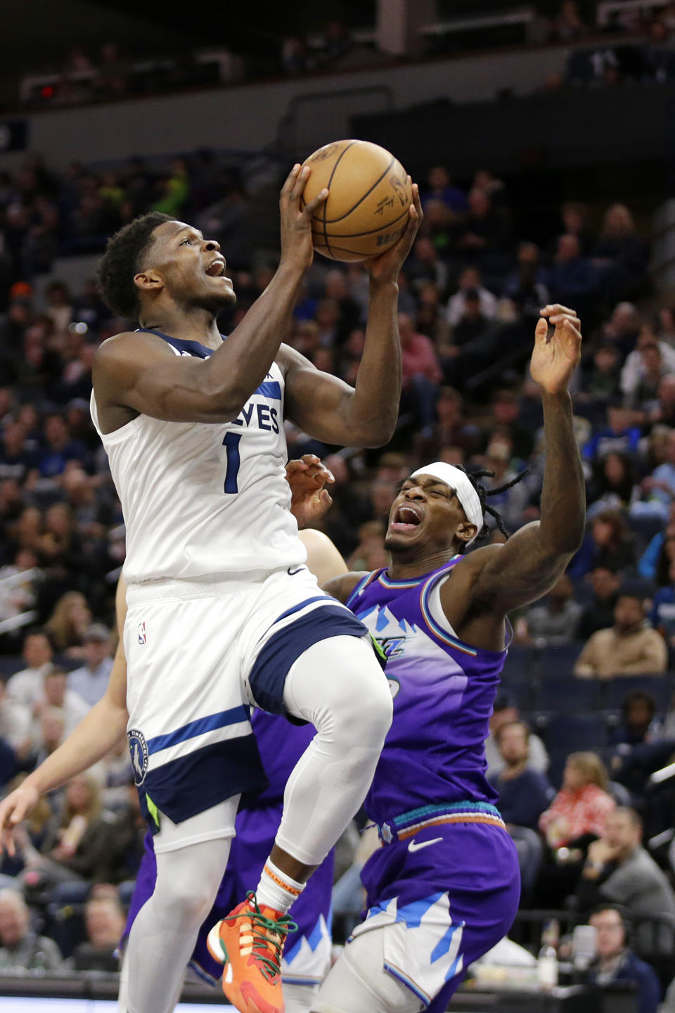 Minnesota Timberwolves guard Anthony Edwards (1) shoots against Utah Jazz forward Jarred Vanderbilt, right, in the fourth quarter of an NBA basketball game Monday, Jan. 16, 2023, in Minneapolis. (AP Photo/Andy Clayton-King)