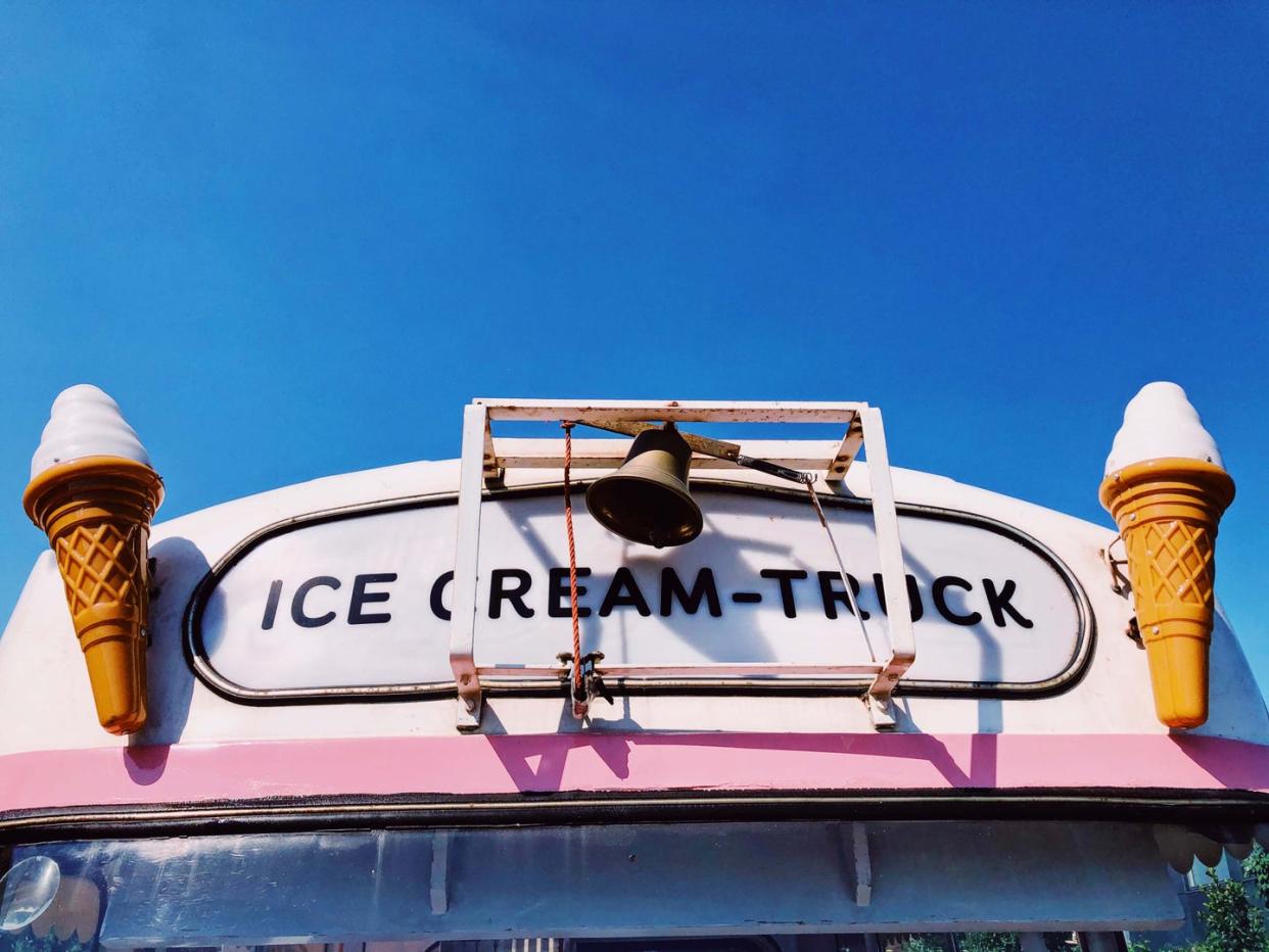 ice cream truck in pink with a blue sky at the beach pastel colours summer vibes