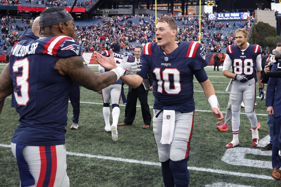 New England Patriots quarterback Mac Jones (10) celebrates with linebacker Mack Wilson Sr., left, following a 29-25 win against the Buffalo Bills after an NFL football game, Sunday, Oct. 22, 2023, in Foxborough, Mass. (AP Photo/Winslow Townson)