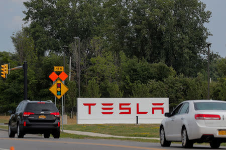 Cars pass by the Tesla Inc. Gigafactory 2, which is also known as RiverBend, a joint venture with Panasonic to produce solar panels and roof tiles in Buffalo, New York, U.S., August 2, 2018. REUTERS/Brendan McDermid/Files