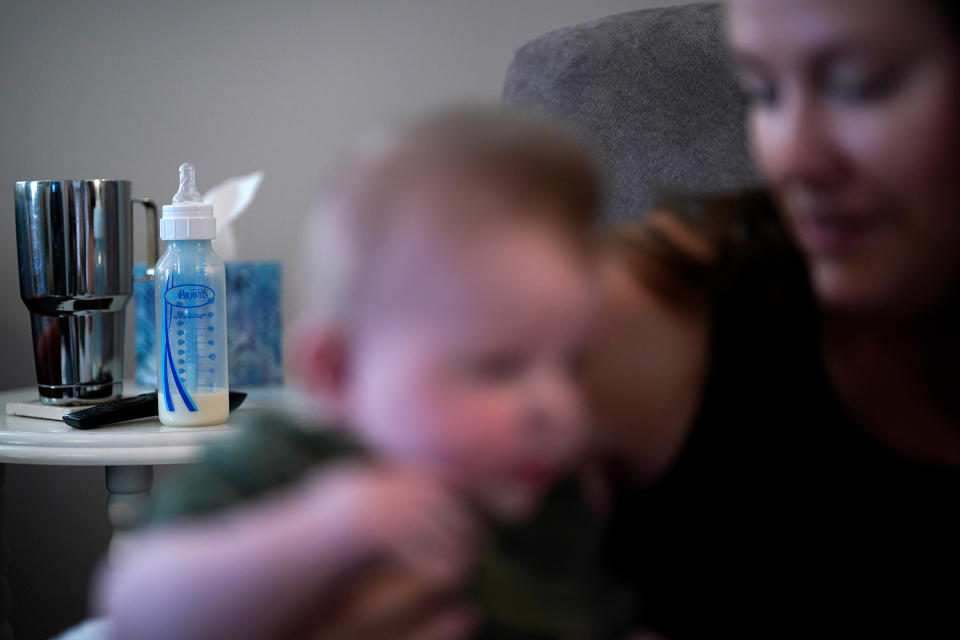 Ashley Maddox holds her 5-month-old son, Cole, after feeding him with formula she bought through a Facebook group of mothers in need Thursday, May 12, in Imperial Beach, Calif.<span class="copyright">Gregory Bull—AP</span>