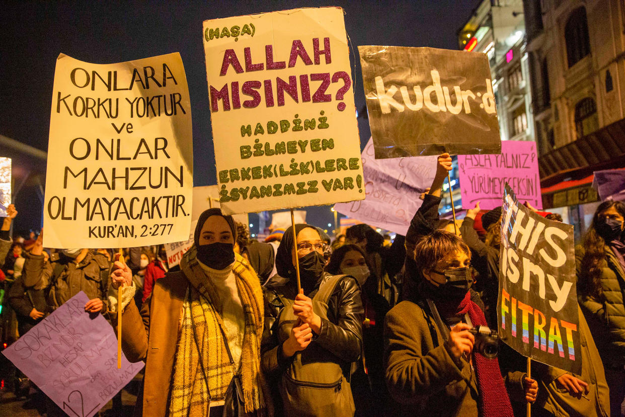 Women at a feminist night march hold posters reading, “Are you God? We’re rebelling against unrestrained men and masculinity,” and, “On them shall be no fear, nor shall they grieve,” Quran verse 2:277