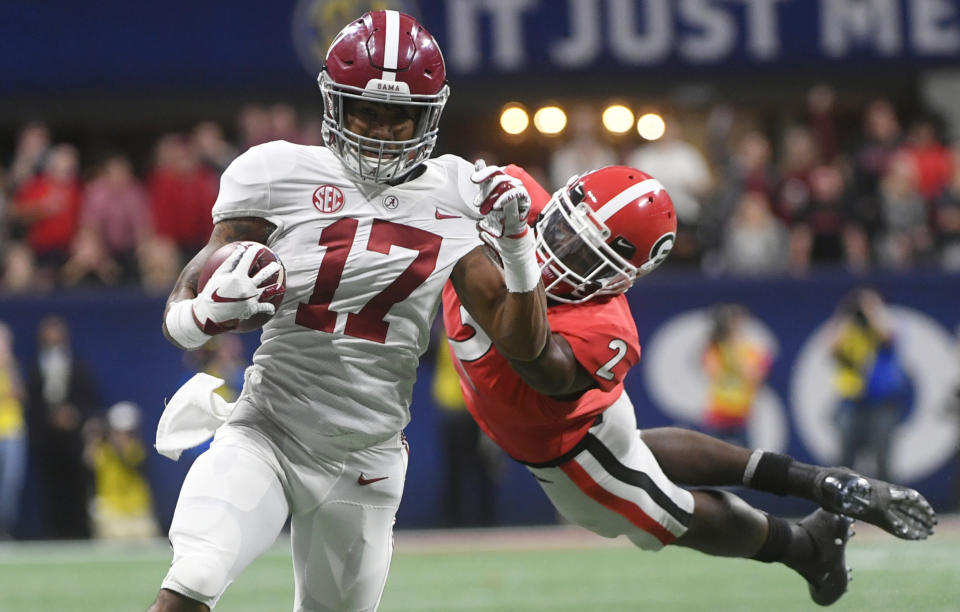 Georgia defensive back Richard LeCounte (2) misses the tackle on Alabama wide receiver Jaylen Waddle (17) during the second half of the Southeastern Conference championship NCAA college football game, Saturday, Dec. 1, 2018, in Atlanta. Waddle scored a touchdown on the play. (AP Photo/John Amis)