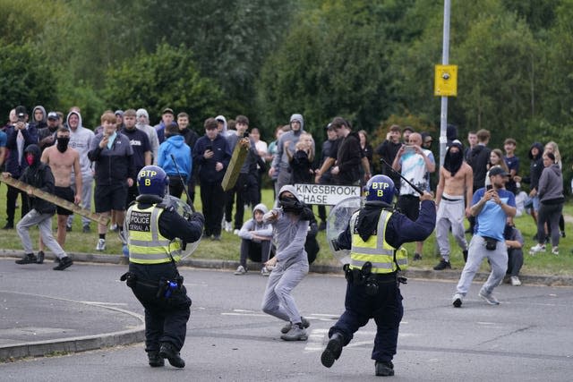 Police face violent protesters during an anti-immigration demonstration near the Holiday Inn Express in Rotherham on August 4 