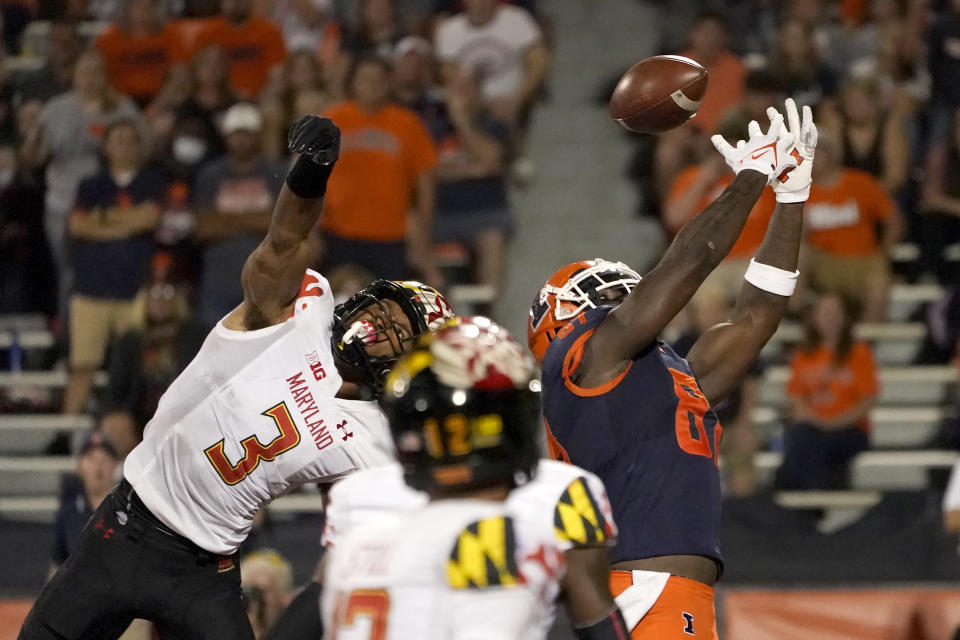 Illinois tight end Daniel Barker, right, is unable to catch a pass in the end zone from quarterback Brandon Peters as Maryland defensive back Nick Cross defends during the first half of an NCAA college football game Friday, Sept. 17, 2021, in Champaign, Ill. (AP Photo/Charles Rex Arbogast)