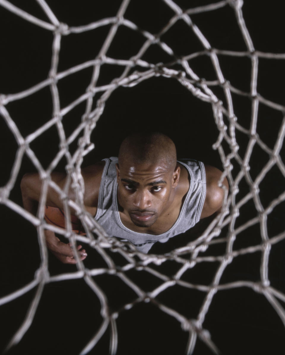Vince Carter #15, Power Forward for the Toronto Raptors looks up through the net during a photoshoot for Puma Sportswear on 17th August 1998 at the Chelsea Piers basketball courts in Manhattan, New York City, New York, United States.