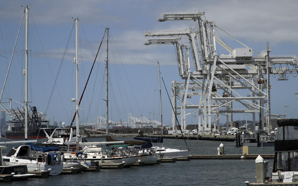 FILE - In this photo taken on Friday, May 17, 2019, shipping cranes and a marina are seen near the Howard terminal area of the Port of Oakland in Oakland, Calif. Major League Baseball instructed the Athletics to explore relocation options as the team tries to secure a new ballpark it hopes will keep the club in Oakland in the long term. A's owner John Fisher said in a statement he will honor MLB's instructions but remains committed to continuing to pursue the waterfront ballpark proposed for construction in the city's Howard Terminal location, close to the popular Jack London Square neighborhood. (AP Photo/Ben Margot, File)