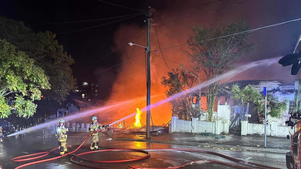 Multiple Ambulance crews are on standby to assist Queensland Fire and Emergency Services - QFES at a major fire  involving several properties in the Brisbane suburb of Woolloongabba. Picture: QAS via NCA NewsWire