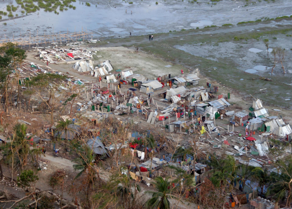 This Nov. 24, 2007 file photo provided by the U.S. Navy, shows an aerial view of shows temporary shelters and damage to a village and infrastructure following Cyclone Sidr, which swept into southern Bangladesh Nov. 15, as seen from a U.S.Marine  Corps aid helicopter. Extreme storms, droughts and heat waves are getting so much worse because global warming that the world has to prepare for an unprecedented onslaught of deadly and costly weather disaster, an international panel of experts says. (AP Photo/Navy-Marine Corps, Sgt. Ezekiel R. Kitandwe, File)