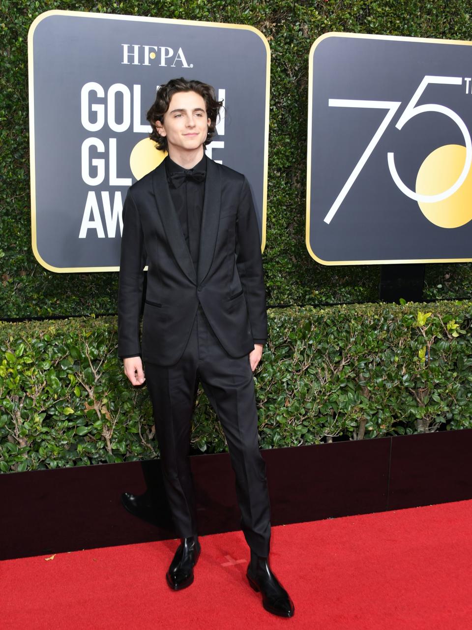 Timothée Chalamet in a black Berluti suit at the 2018 Golden Globe Awards. (Image via Getty Images)