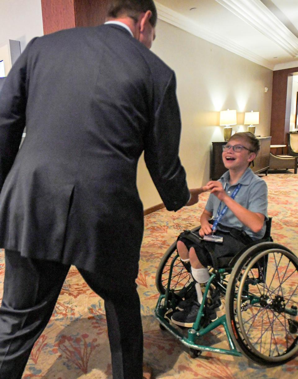 Clemson head coach Dabo Swinney greets fan Noah Fike of Rock Hill, S.C. during the ACC Kickoff Media Days event in downtown Charlotte, N.C. Thursday, July 27, 2023. Fike, 12, with the Dream On 3 sports wishes group, met quarterback Cade Klubnik and coach.