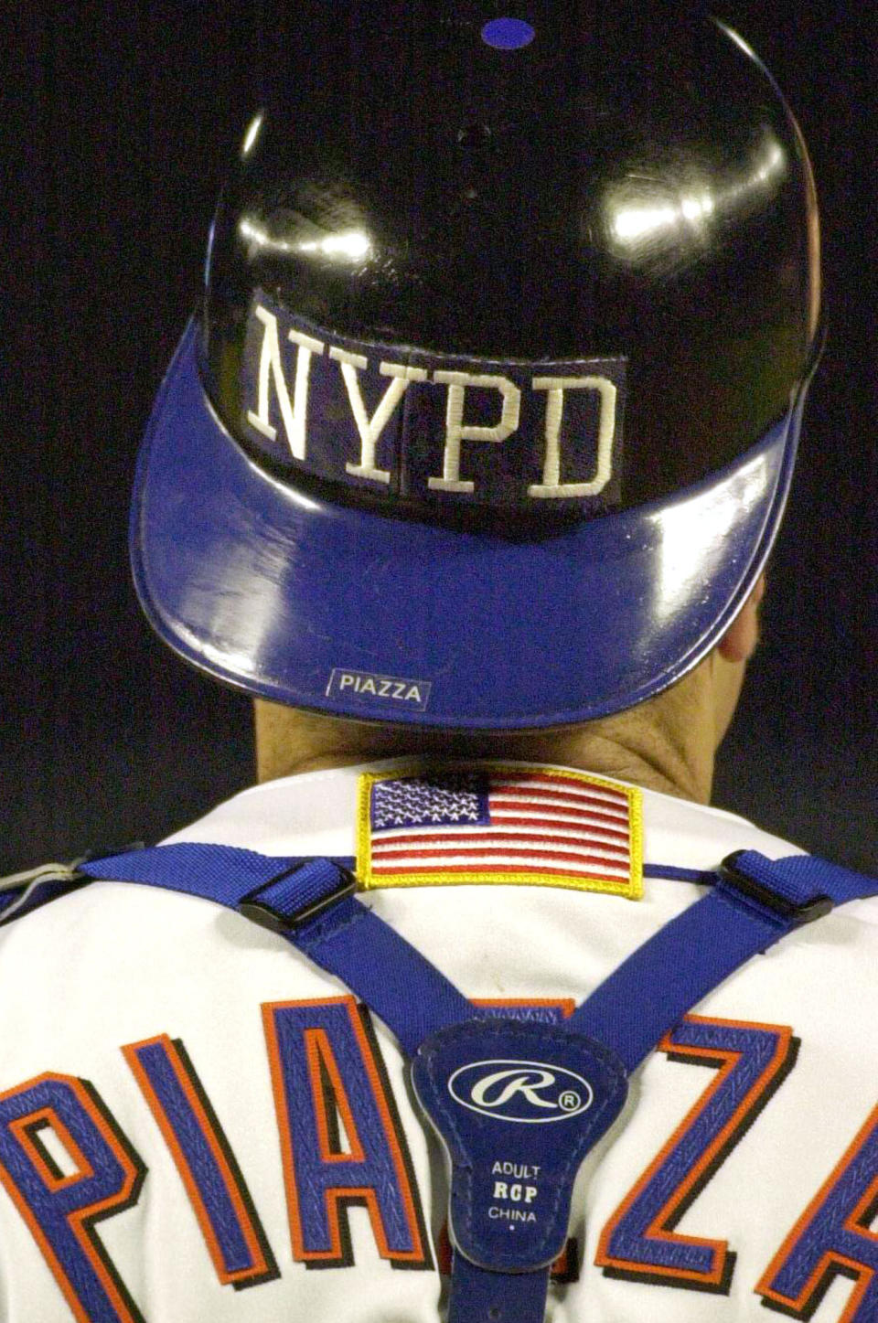 FILE- In this Sept. 21, 2001, file photo, New York Mets catcher Mike Piazza wears the NYPD logo on his helmet as he takes the field in the top of the fifth inning against the Atlanta Braves in New York. (AP Photo/Mark Lennihan, File)