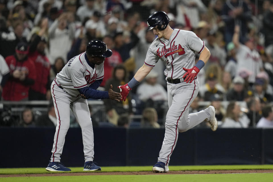 Atlanta Braves' Sean Murphy, right, celebrates with third base coach Ron Washington after hitting a home run during the fourth inning of a baseball game against the San Diego Padres, Tuesday, April 18, 2023, in San Diego. (AP Photo/Gregory Bull)