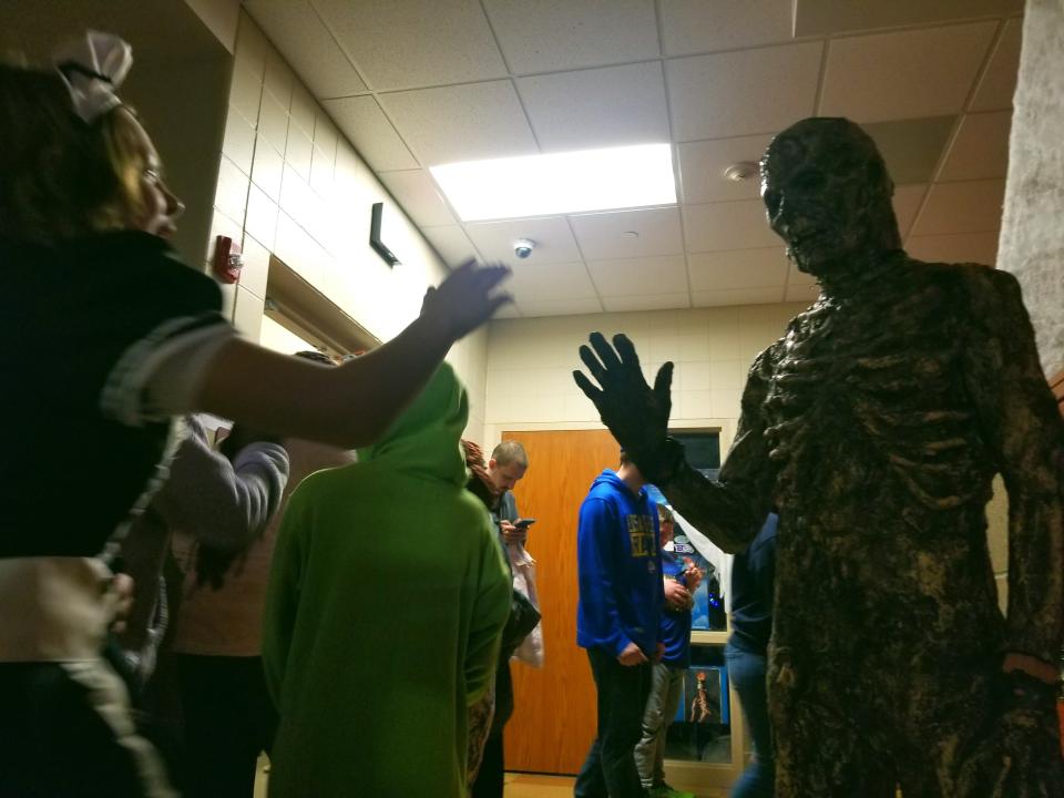 Trick-or-Treaters greet the monsters giving out candy at Edward Stone Middle School's "Haunted Halls" safe trick-or-treating event on Thursday, Oct. 27, 2022.