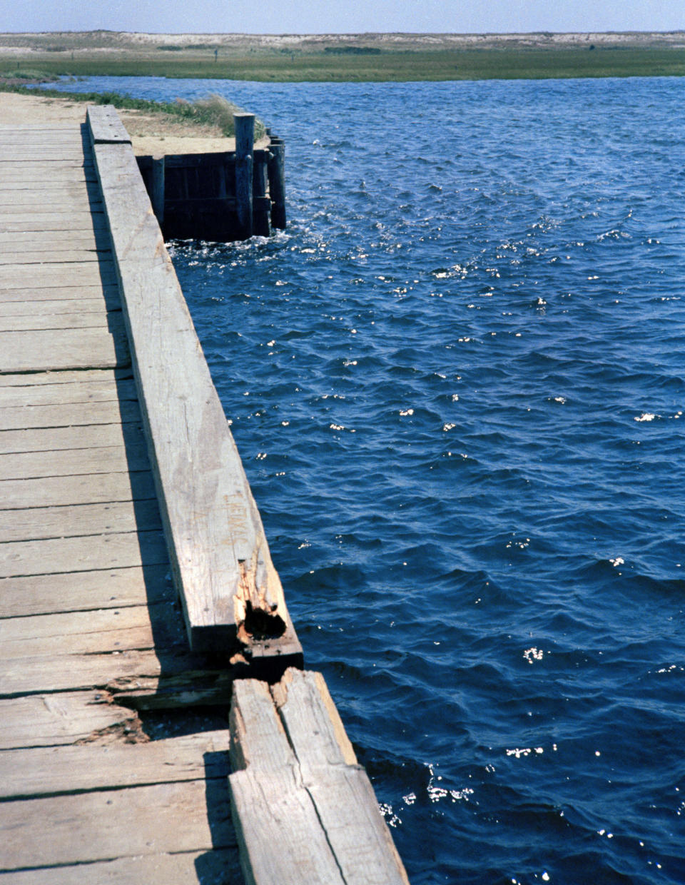 FILE - In this file photograph from 1969, skid marks and deck damage is seen on the Dyke Bridge on Chappaquiddick Island in Edgartown, Mass., where U.S. Sen. Edward Kennedy's car plunged off the bridge. It's been 50 years since the fateful automobile accident that killed a woman and thwarted Kennedy's presidential aspirations. (AP Photo, File)