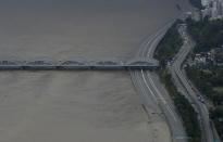 A part of a main road near the Han River is flooded due to heavy rain in Seoul, South Korea, Thursday, Aug. 6, 2020. The state-run Han River Flood Control Office issued a flood alert near a key river bridge in Seoul, the first such advisory since 2011. (AP Photo/Lee Jin-man)