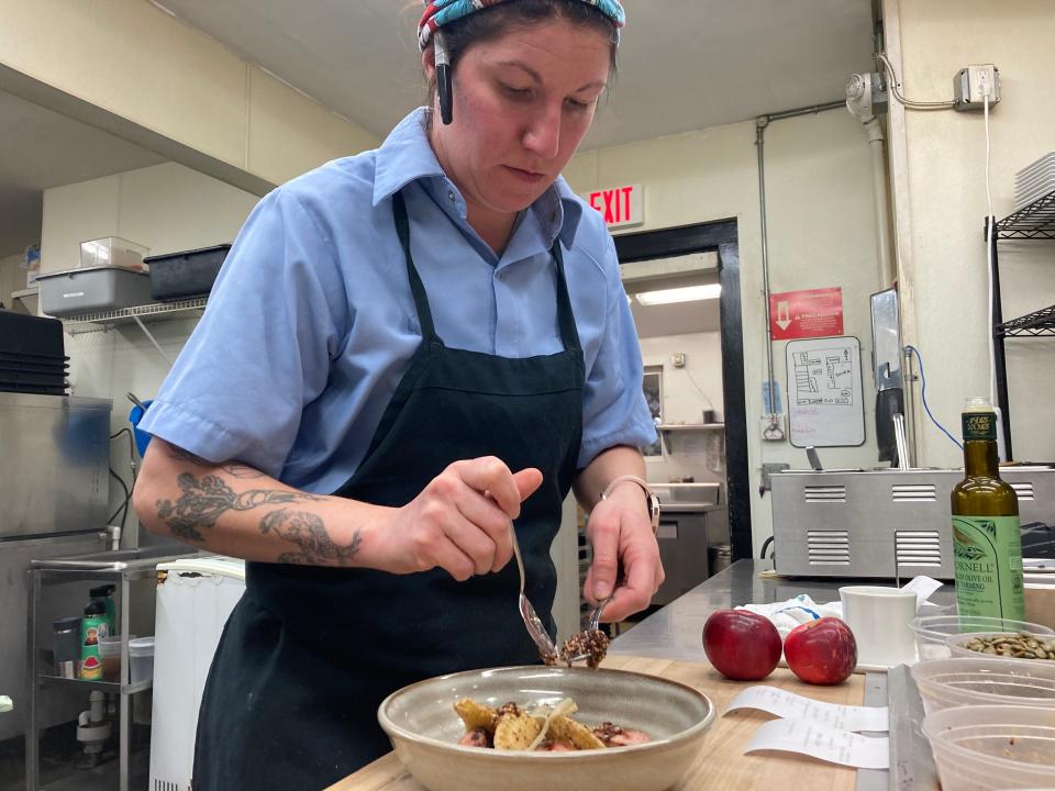 Chef/co-owner Chelsea Morgan plates a sausage-and-pierogis dish Nov. 9, 2022 at Vermont Fine in Richmond.