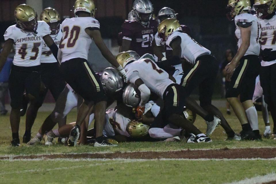 Florida High players tackle a Madison County player in the Seminoles 35-23 win.