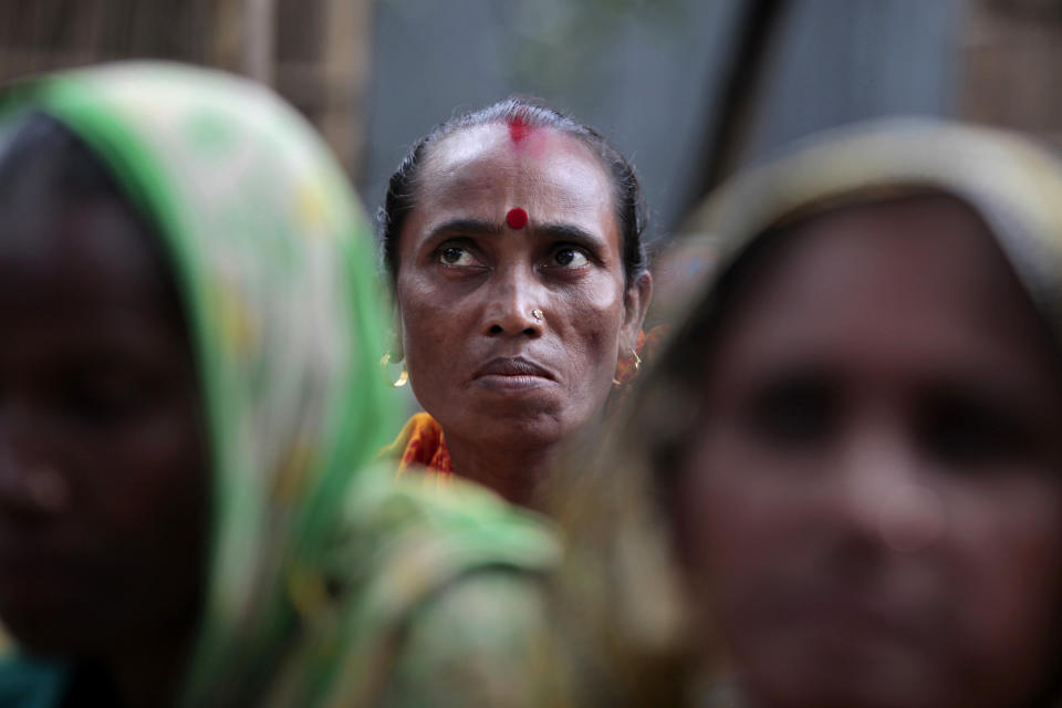 In this Sept. 30, 2012, photo, Bangladeshi woman Shemoli Rani Das listens at their usual weekly meetings at Saghata, a remote impoverished farming village in Gaibandha district, 120 miles (192 kilometers) north of capital Dhaka, Bangladesh. Dozens of “Info Ladies” bike into remote Bangladeshi villages with laptops and Internet connections, helping tens of thousands of people - especially women - get everything from government services to chats with distant loved ones. (AP Photo/A.M. Ahad)