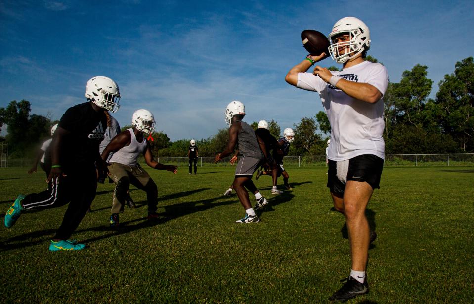 Austin Price, the quarterback for the Dunbar High School football team practices with his team on Wednesday, July 31, 2024.