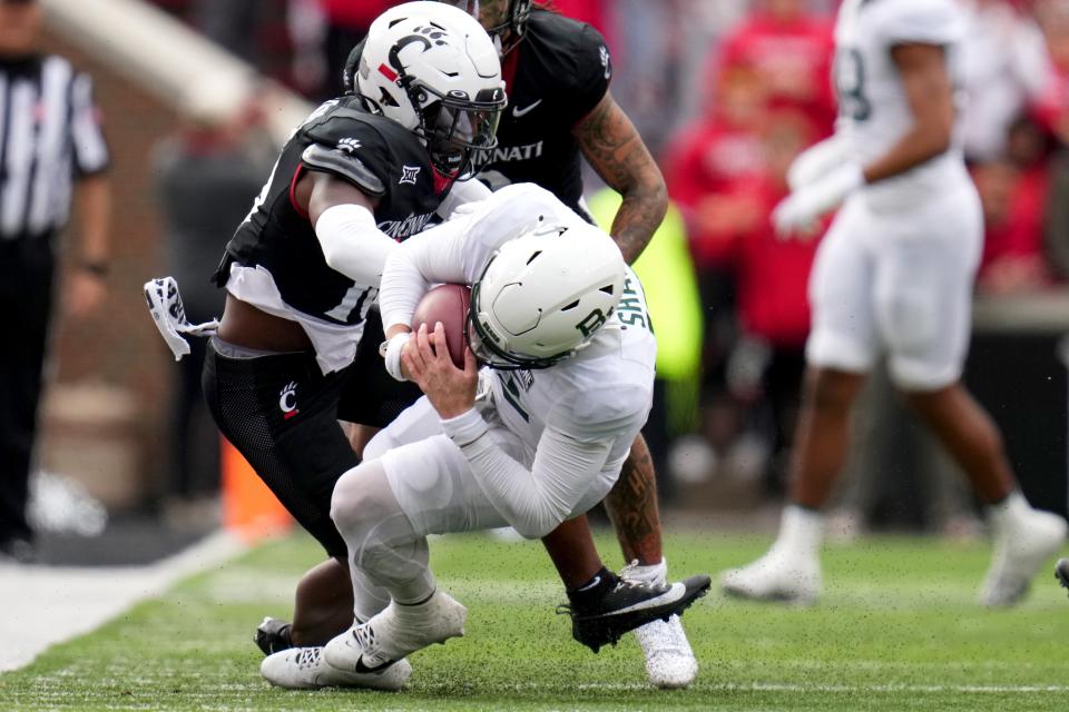 Cincinnati Bearcats safety Bryon Threats (10) tackles Baylor Bears quarterback Blake Shapen (12) on a fourth-down play in the second quarter during a college football game between the Baylor Bears and the Cincinnati Bearcats, Saturday, Oct. 21, 2023, at Nippert Stadium in Cincinnati.