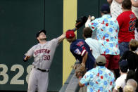 Houston Astros right fielder Kyle Tucker (30) reaches but cannot catch a foul ball off the bat of Minnesota Twins' Alex Kirilloff in the fourth inning of a baseball game, Saturday, June 12, 2021, in Minneapolis. (AP Photo/Jim Mone)