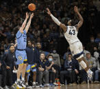 Marquette guard Tyler Kolek (22) takes a three point shot over Villanova forward Eric Dixon (43) during the second half of an NCAA college basketball game, Wednesday, Jan. 19, 2022, in Villanova, Pa. (AP Photo/Laurence Kesterson)