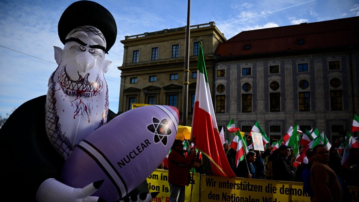  Demonstrators hold Iranian flags and a huge inflated figure representing Iran's Supreme Leader Ali Khamenei holding a nuclear bomb as they protest against the Iranian regime in Germany. 